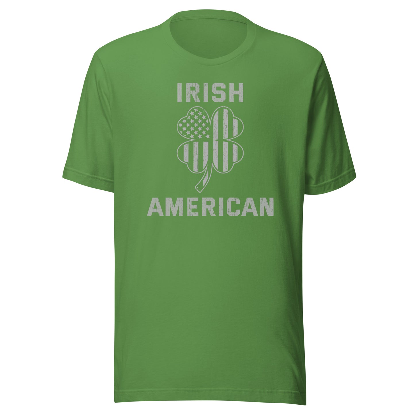 St. Pattys Day tee featuring the words Irish American in bold font with a clover leaf. The clover has an American Flag silhouette within it. Shirt color is leaf green.